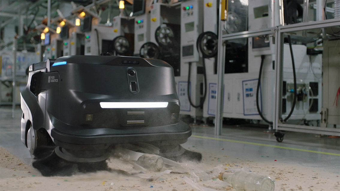 MT1 Sweeper clearing industrial floor debris at full speed